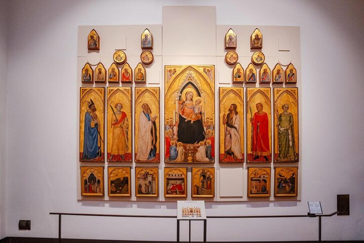 a wall with a bunch of religious paintings on it