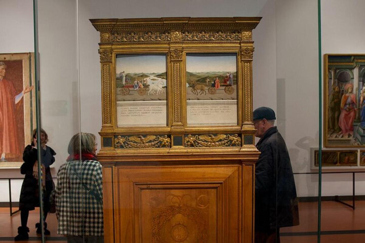 a group of people looking at a painting in a museum
