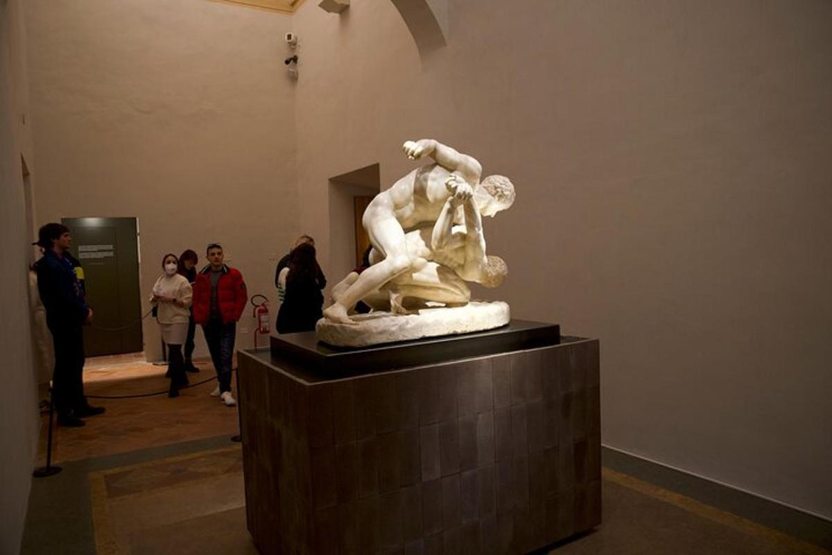 a statue in a museum with people looking at it