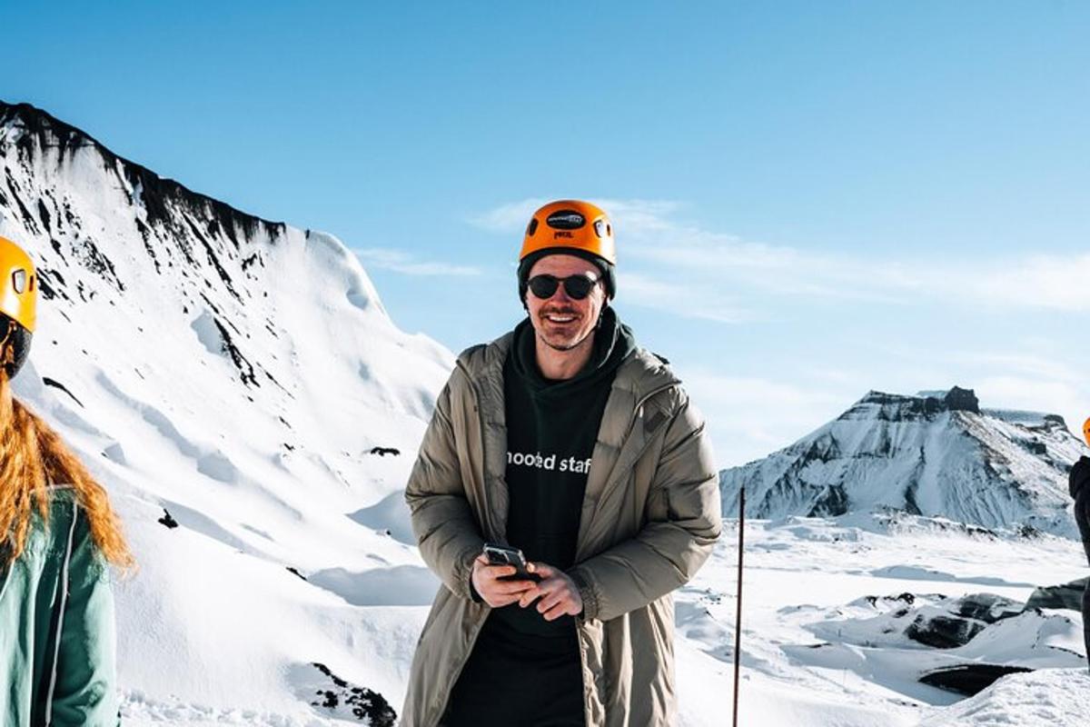 a man standing on top of a snow covered mountain