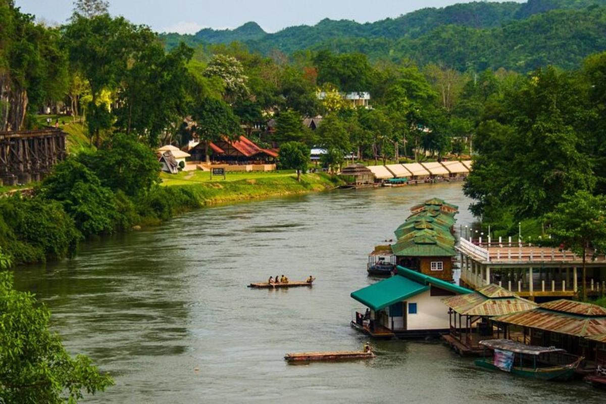 a river with several boats in the middle of a town