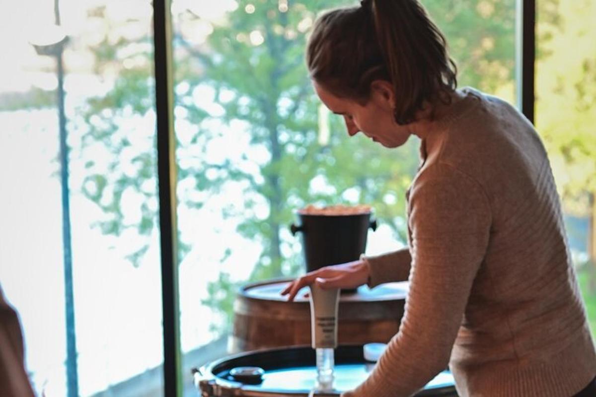 a woman standing next to a table with a glass
