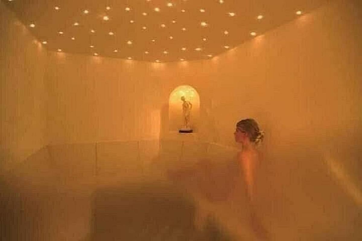 una donna in piedi in una vasca da bagno in una stanza