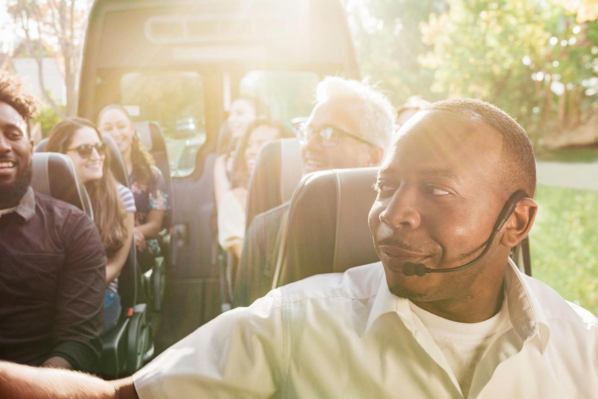 a group of people sitting in the back of a bus