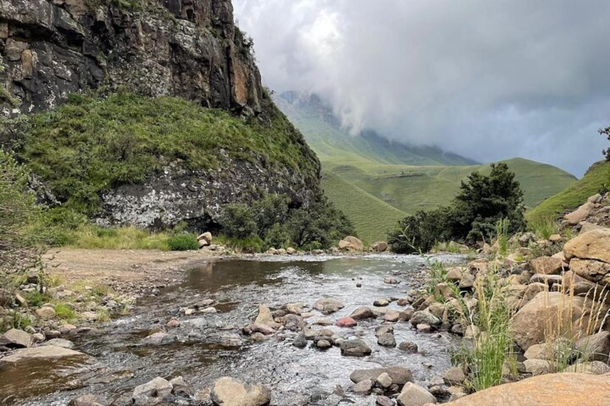 a river with rocks and a mountain in the background