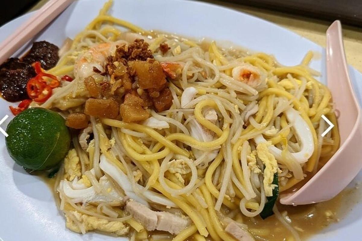 a plate of food with noodles on a table
