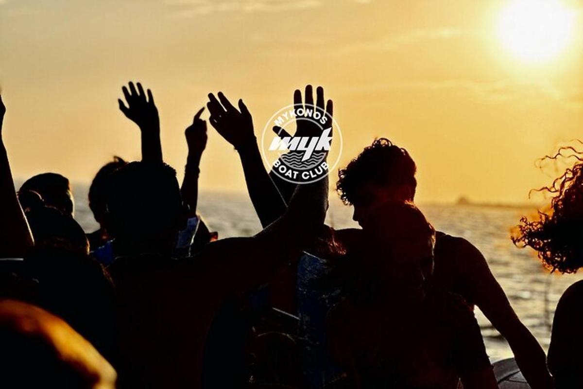 Un grupo de personas con las manos en alto en la playa.