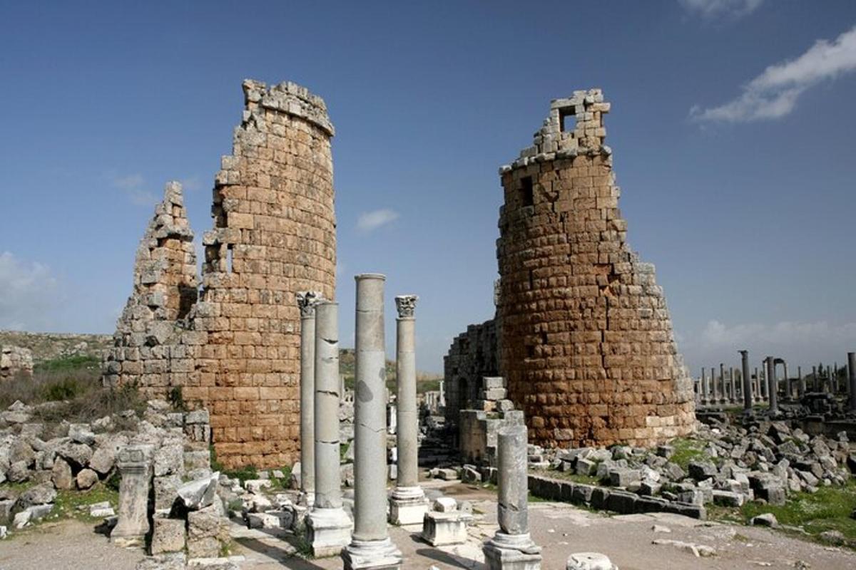 a group of ruins with columns and stone towers