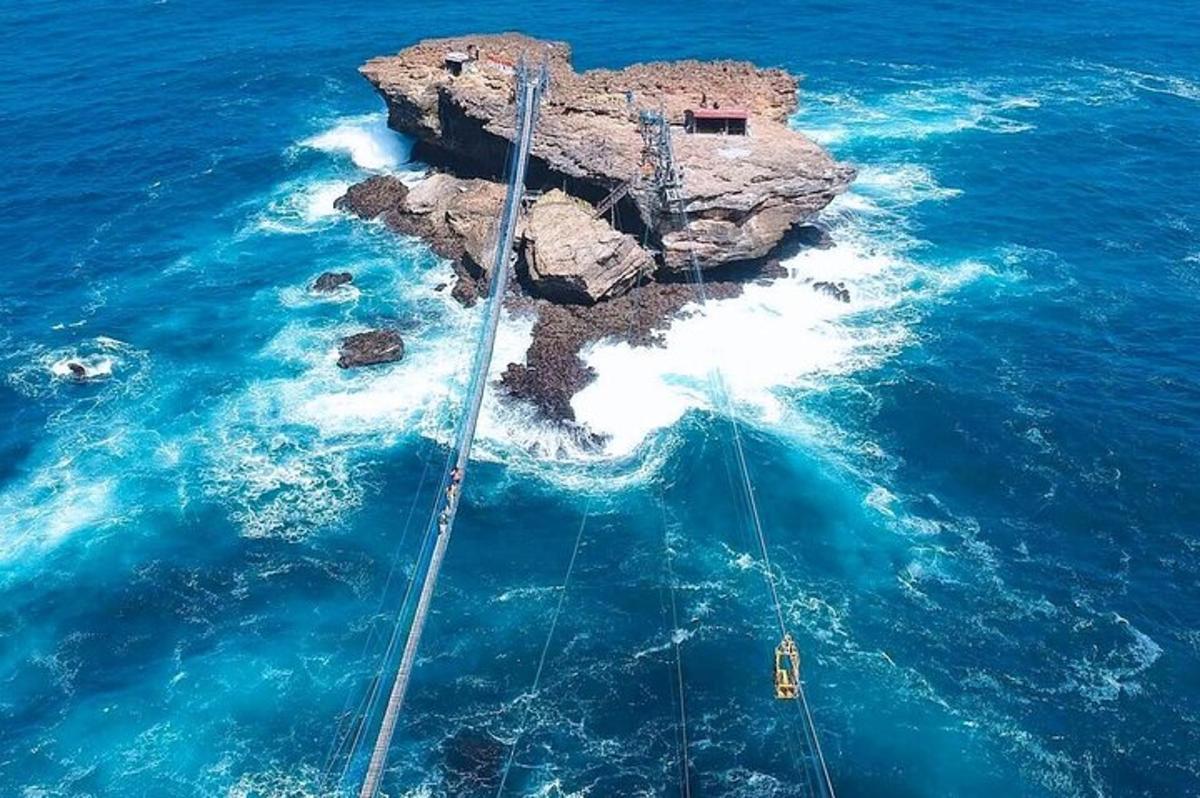 μια βάρκα στο νερό κοντά σε έναν σχηματισμό βράχου