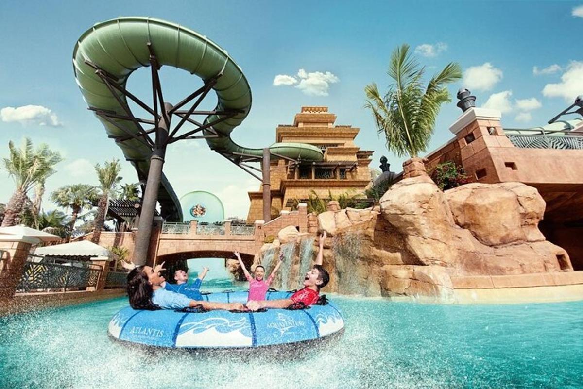 two girls riding on a ride in the water at a theme park