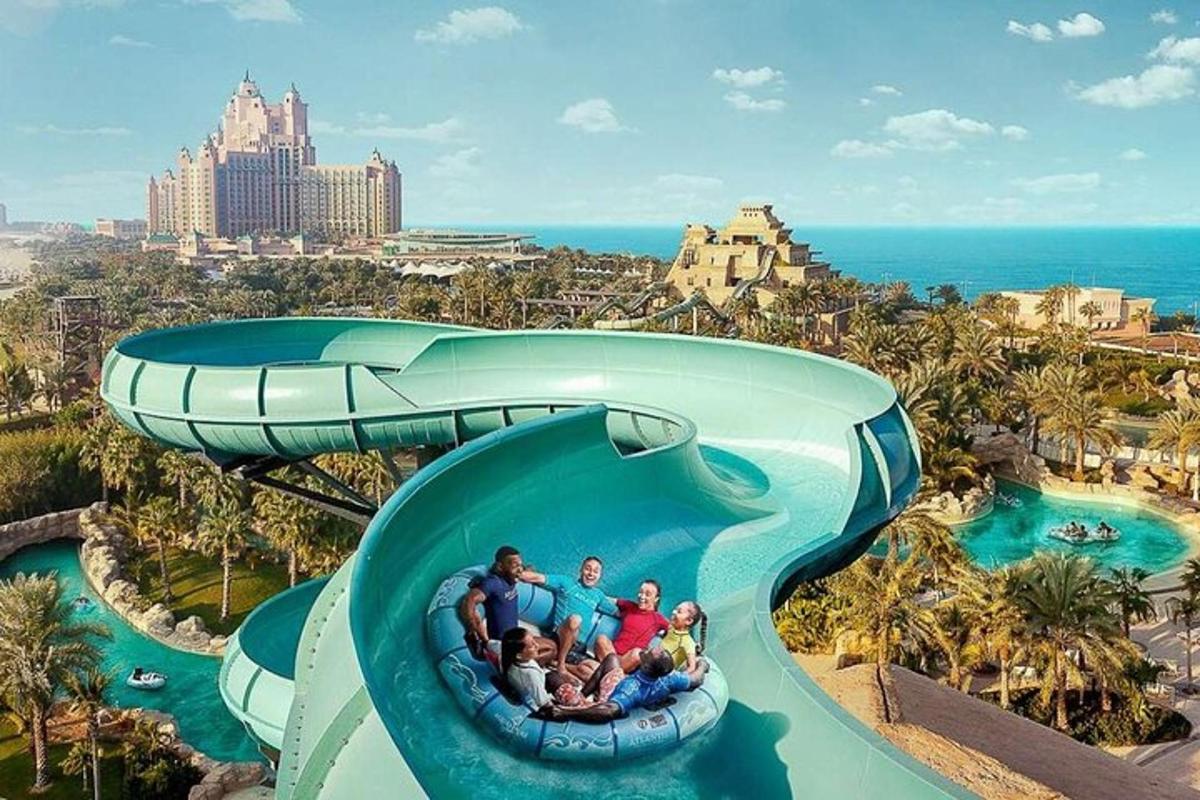 a group of people riding a water slide at a resort