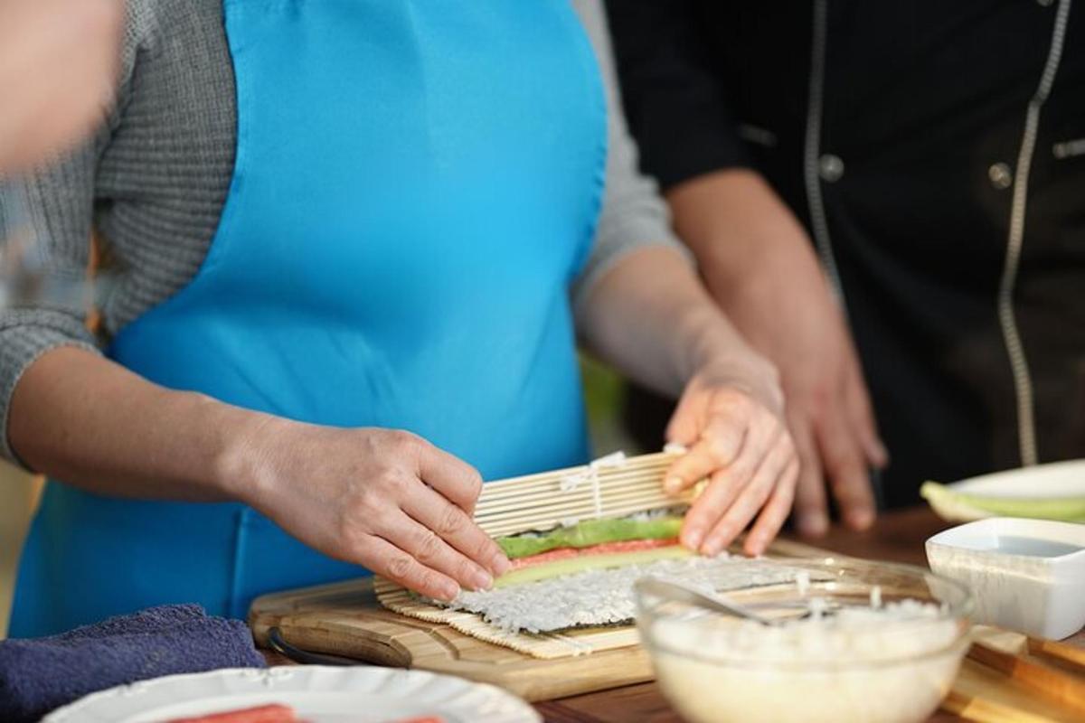 a group of people preparing food on a cutting board