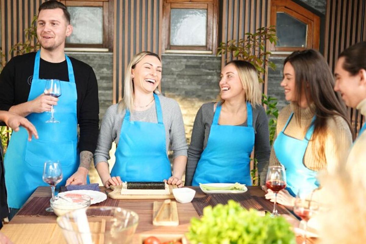 a group of people wearing aprons standing around a table