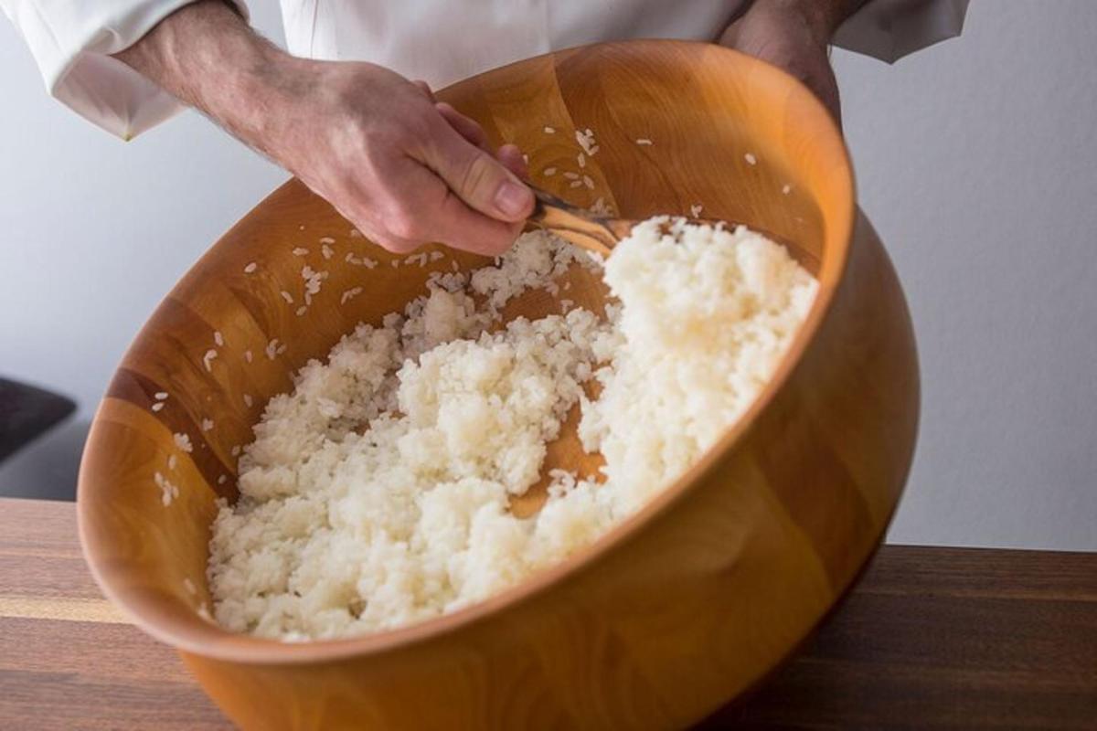 a person mixing rice in a bowl with a spoon
