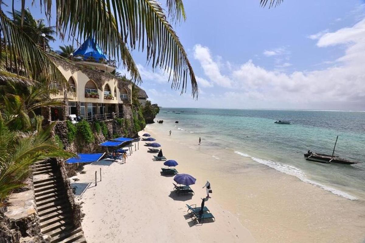 a beach with chairs and umbrellas and the ocean
