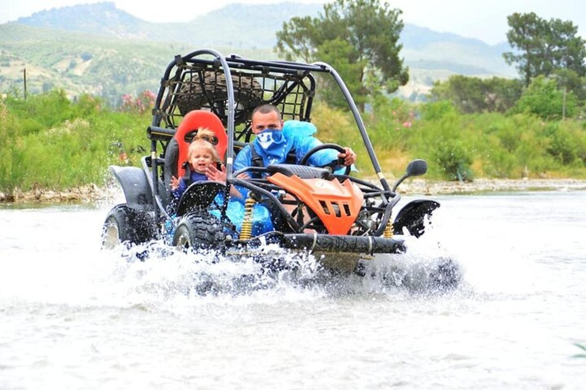 isang lalaki at isang bata na nakasakay sa isang atv sa tubig