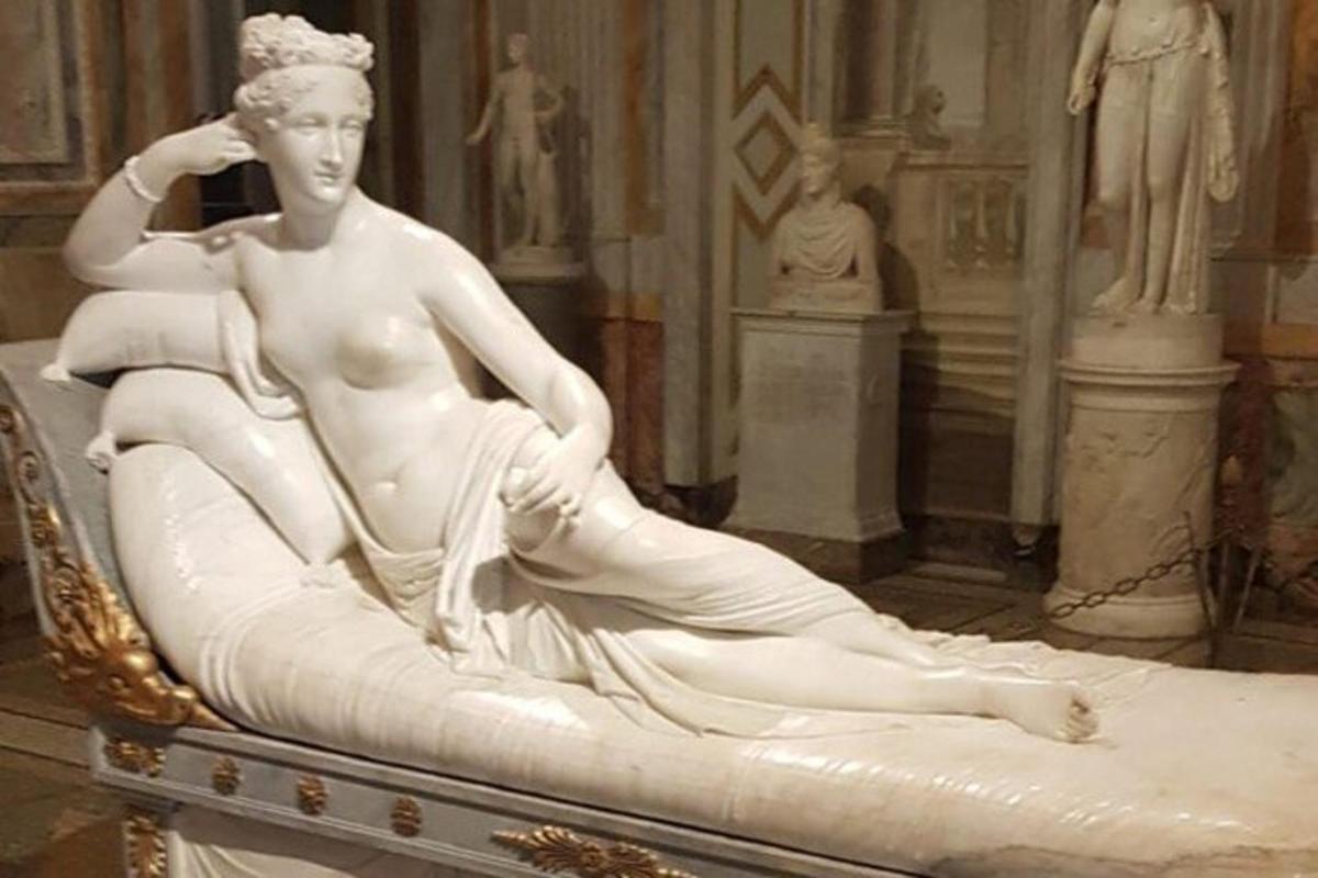 a statue of a woman sitting in a chair