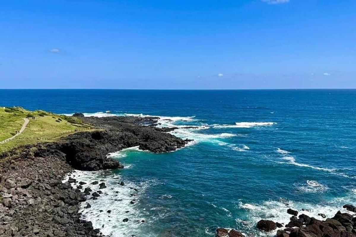 a view of the ocean with rocks and water