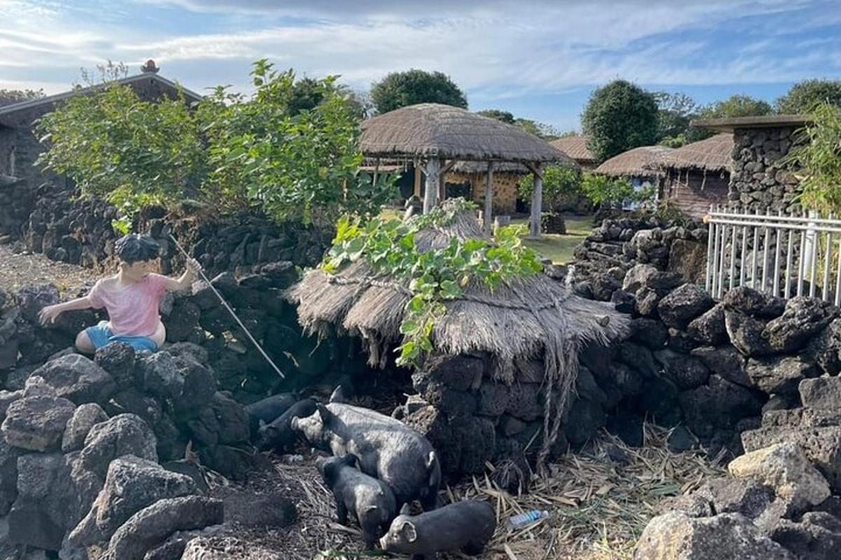 a young girl sitting on rocks next to a pig