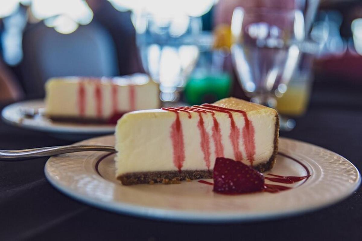 a piece of cake on a plate with a strawberry