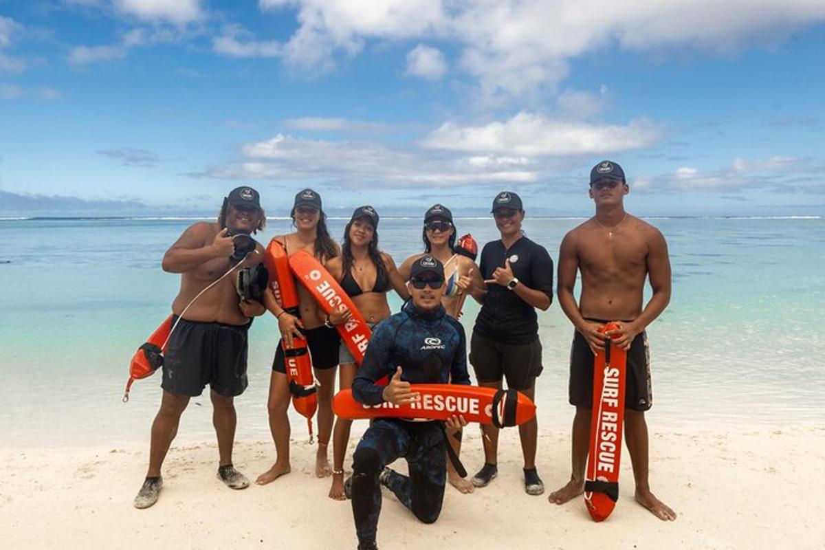 a group of people posing for a picture on the beach