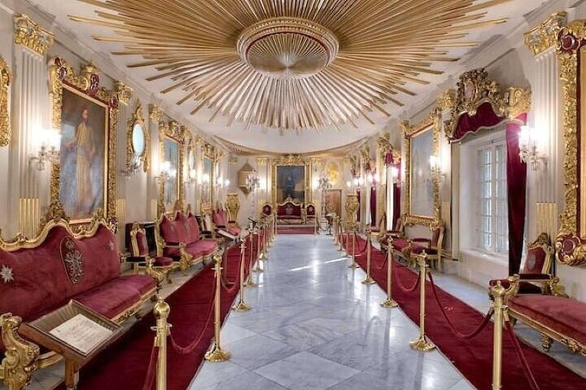 a room with red chairs and a large ceiling