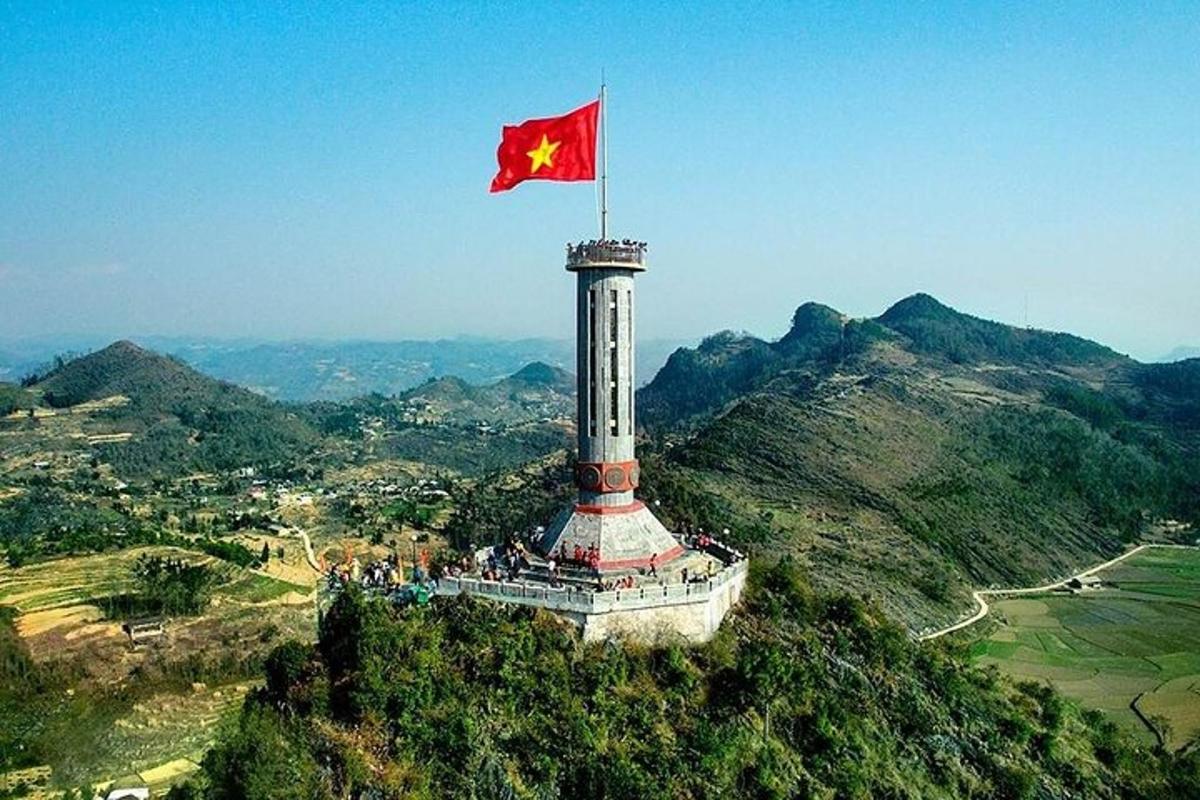 a flag on top of a lighthouse on a mountain