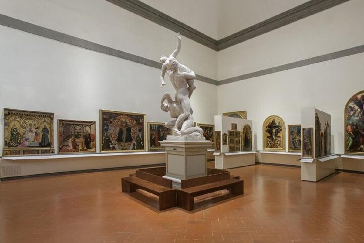 a statue in a museum with paintings on the walls