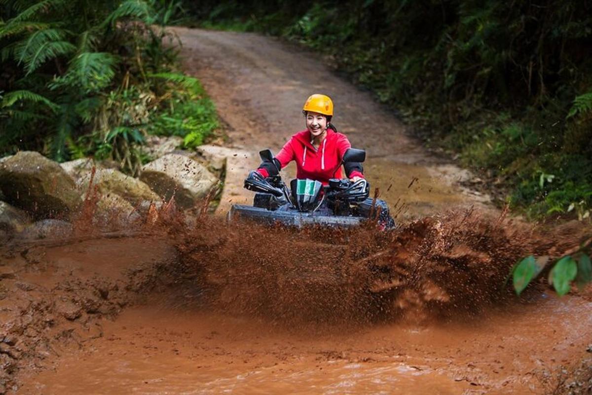 a man riding a four wheeler on a dirt road