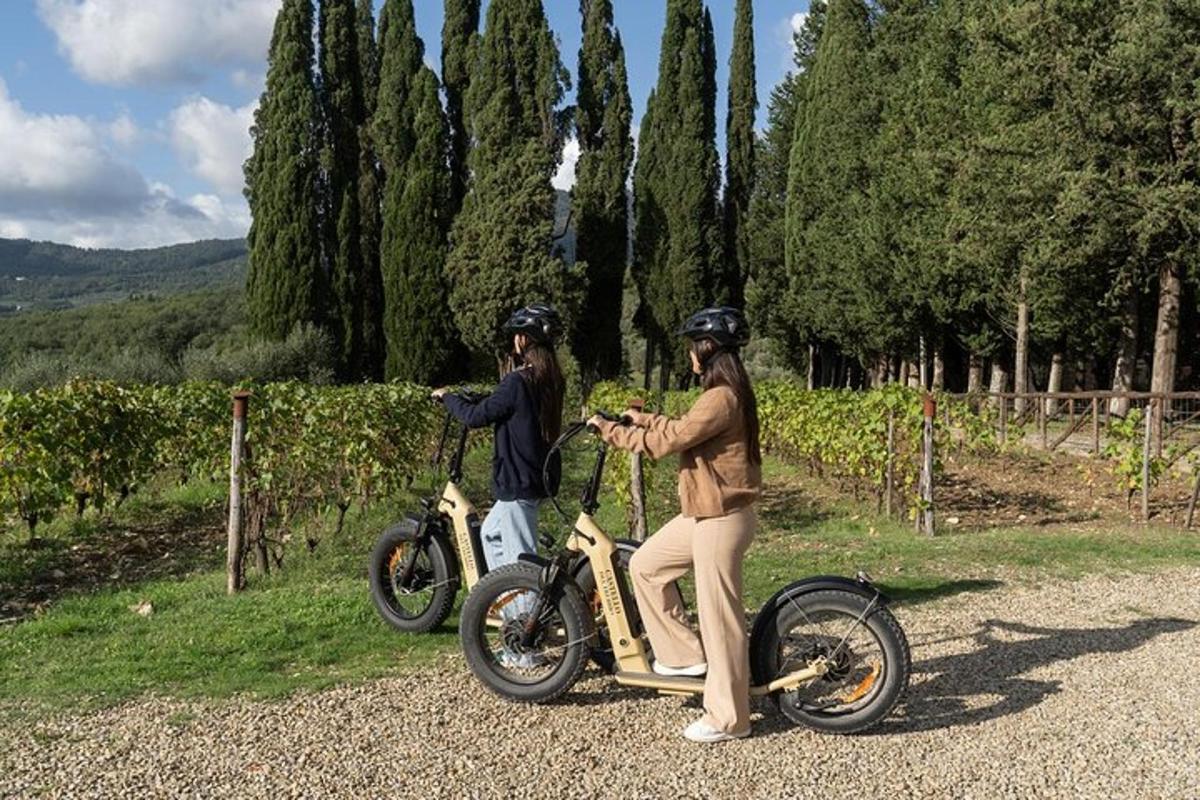 two people riding on a motor scooter on a road