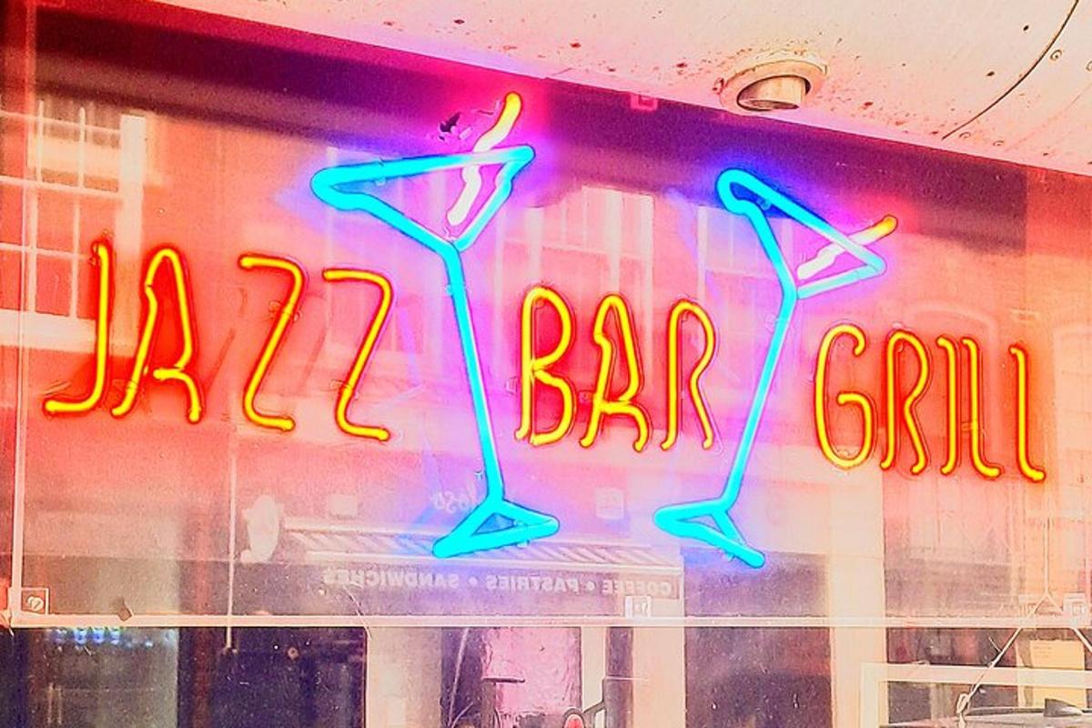a neon sign in the window of a bar