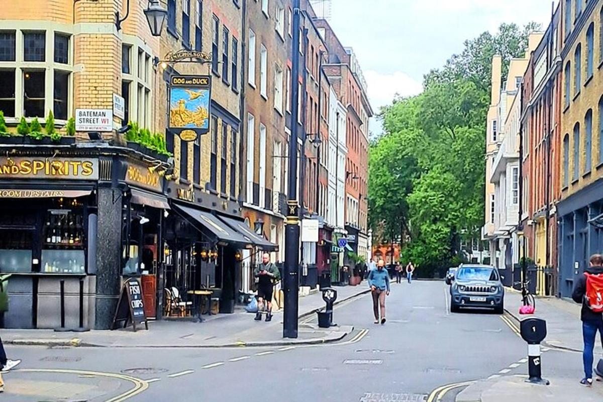a city street with people walking and a car on the road