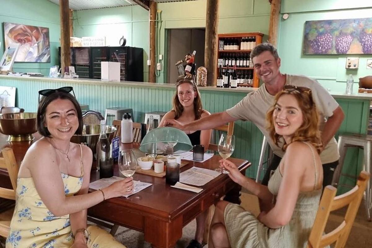 a group of people sitting around a table with wine glasses