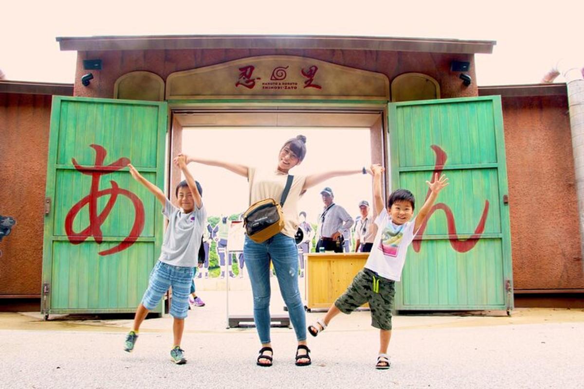 a woman and two children jumping in front of a building