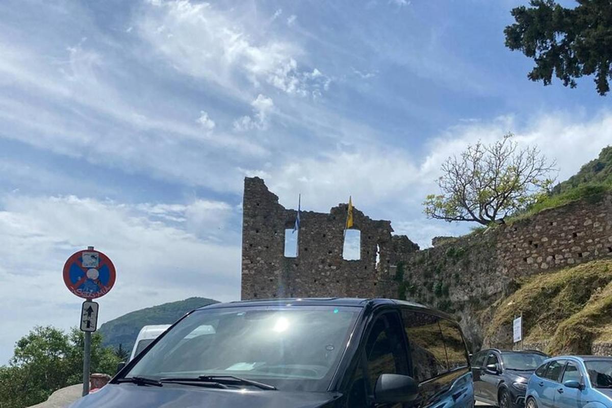 ein Auto, das auf einem Parkplatz neben einem Schloss geparkt ist