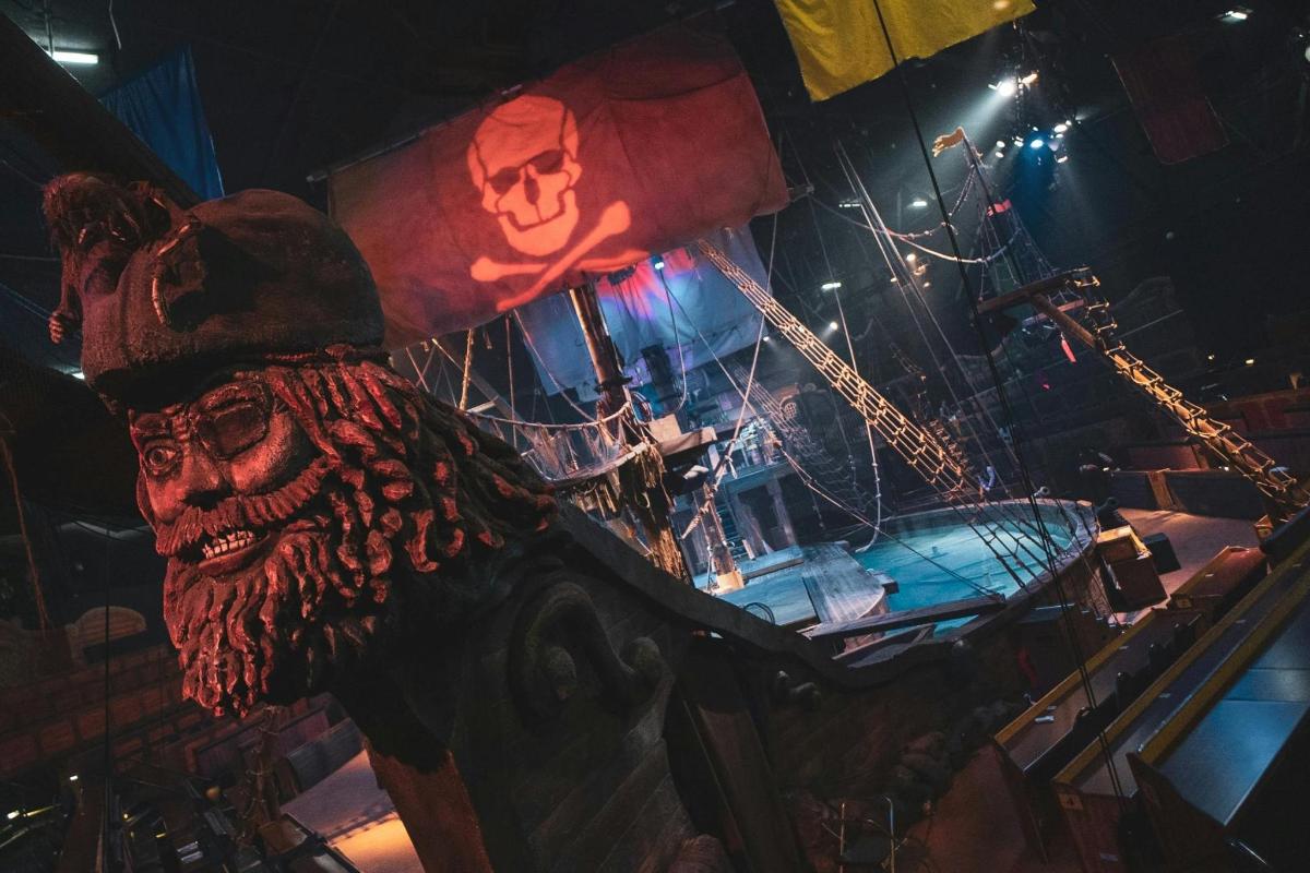 a pirate ship on a stage with a skull