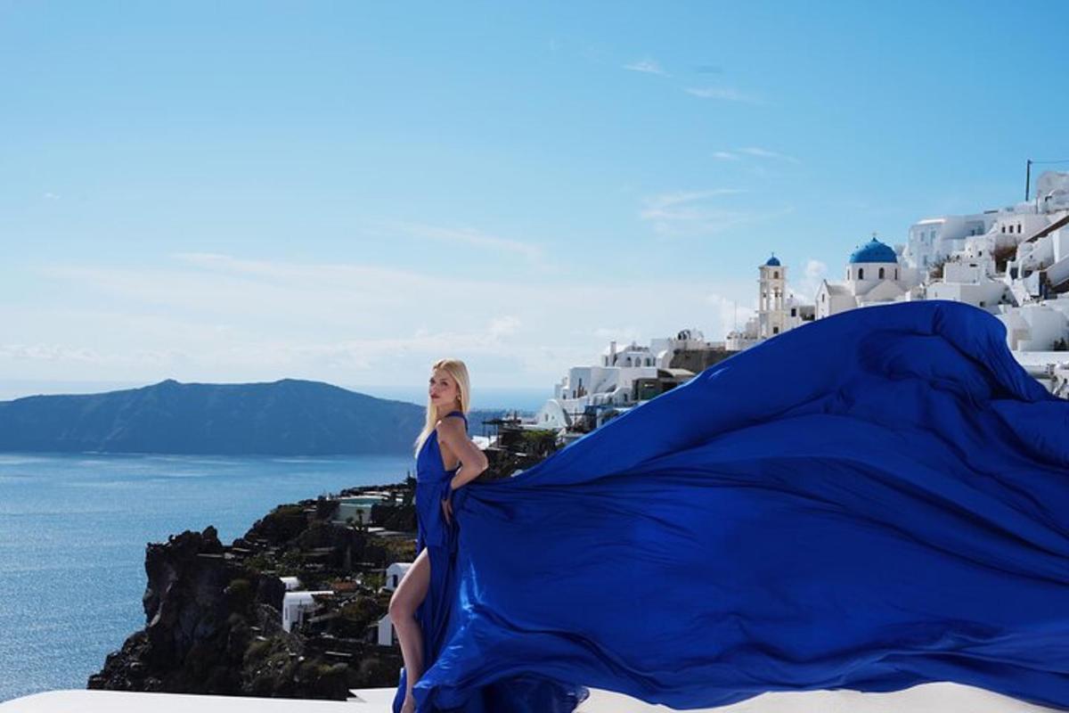 a woman sitting on a cliff holding a blue flag