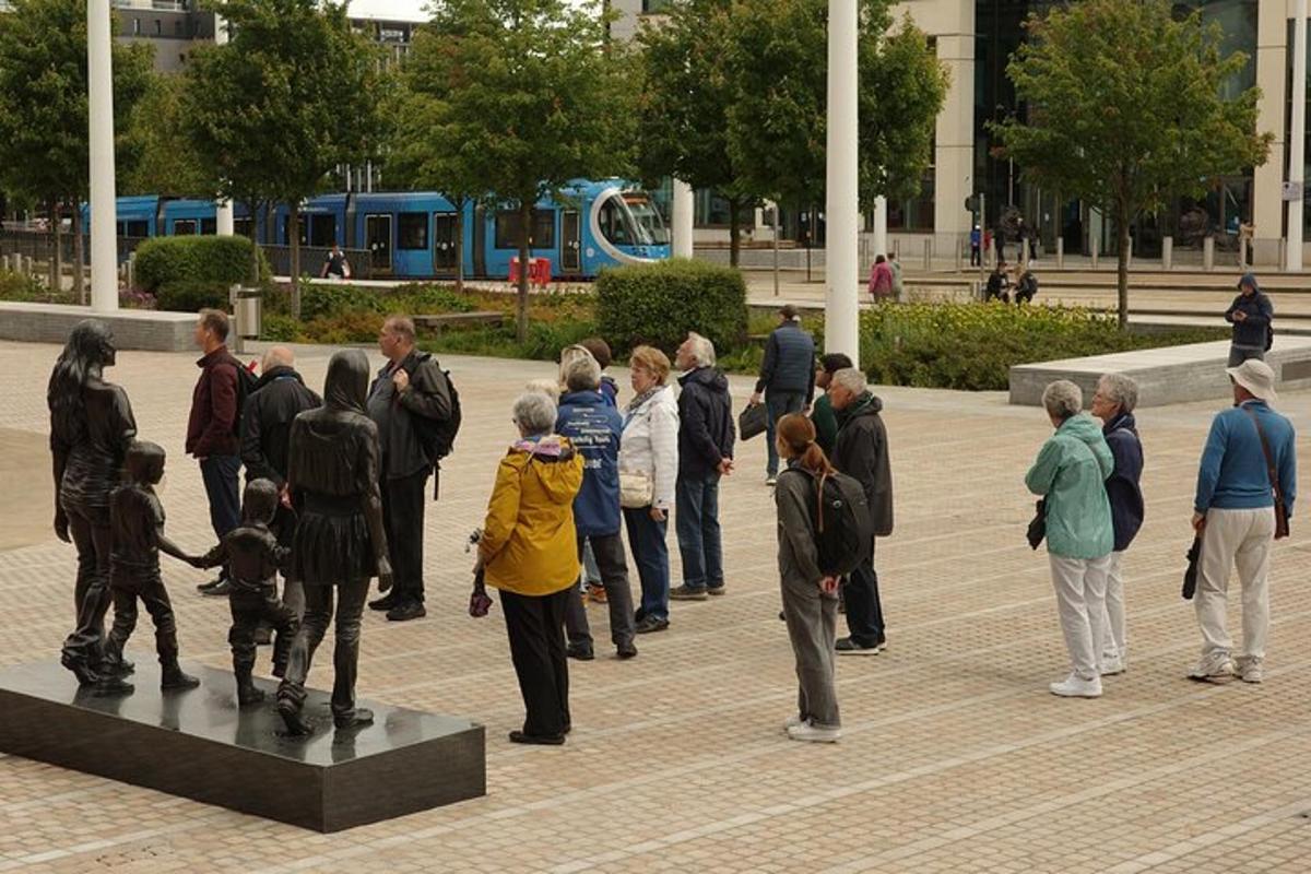 a group of people standing around a statue