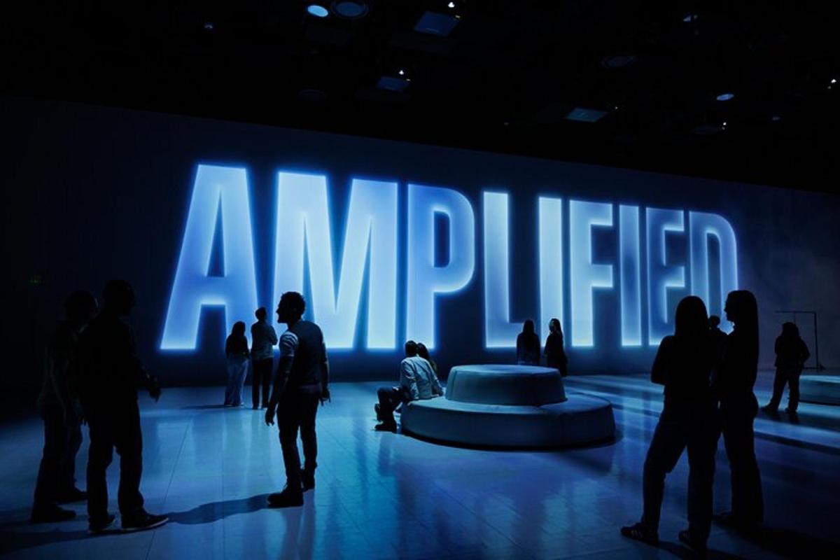 a group of people standing in front of a large sign