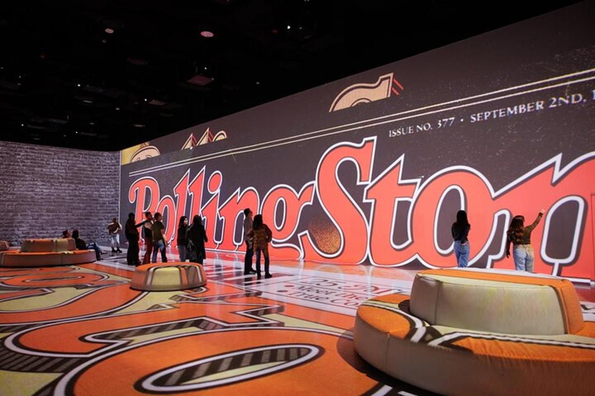 people are standing in a room with a large sign on the wall