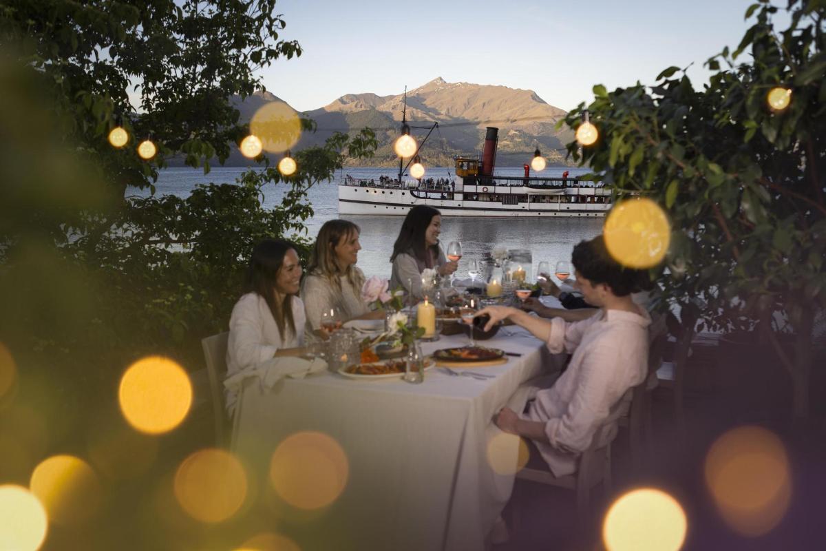 a group of people sitting at a table eating