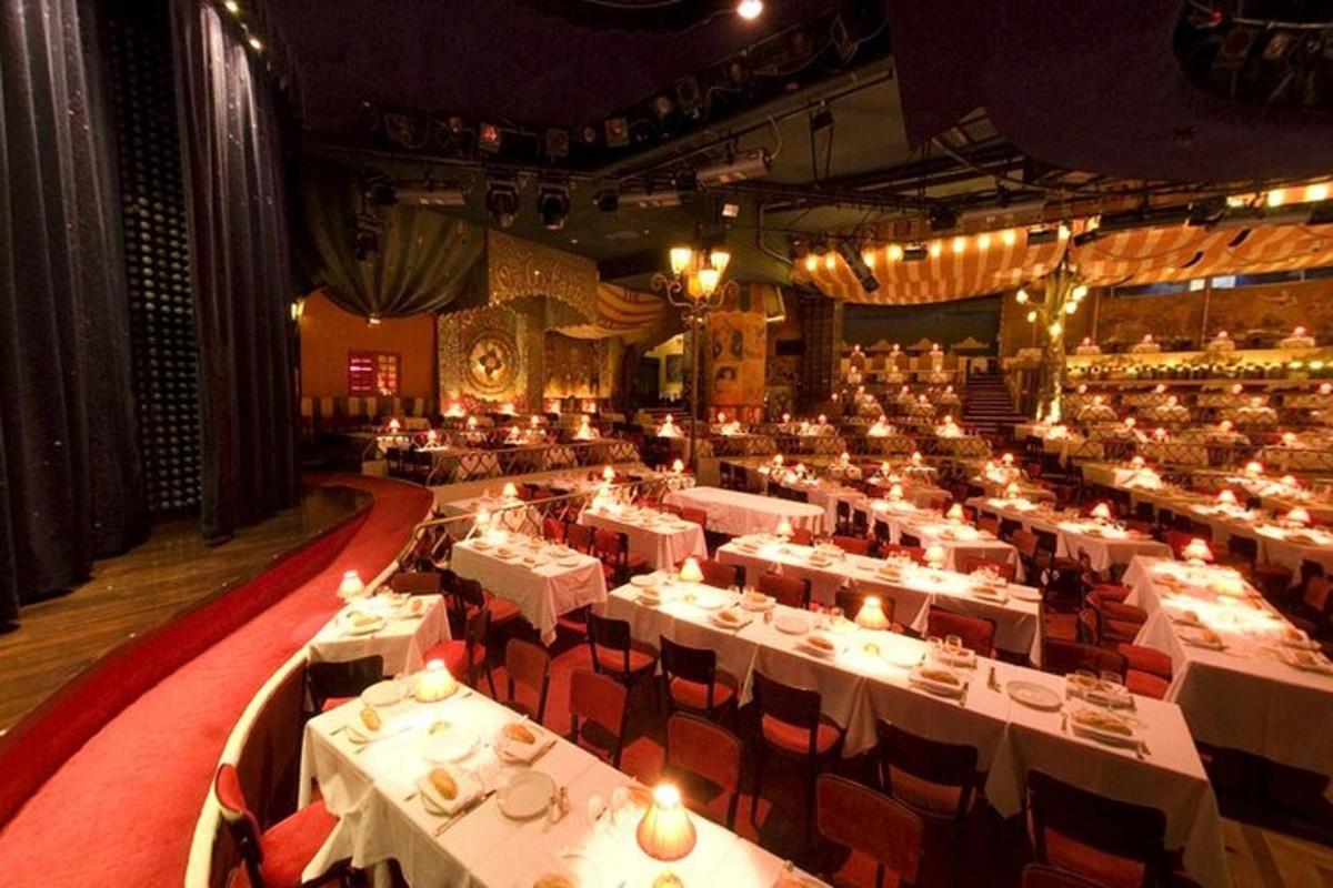 a large dining room with white tables and red chairs