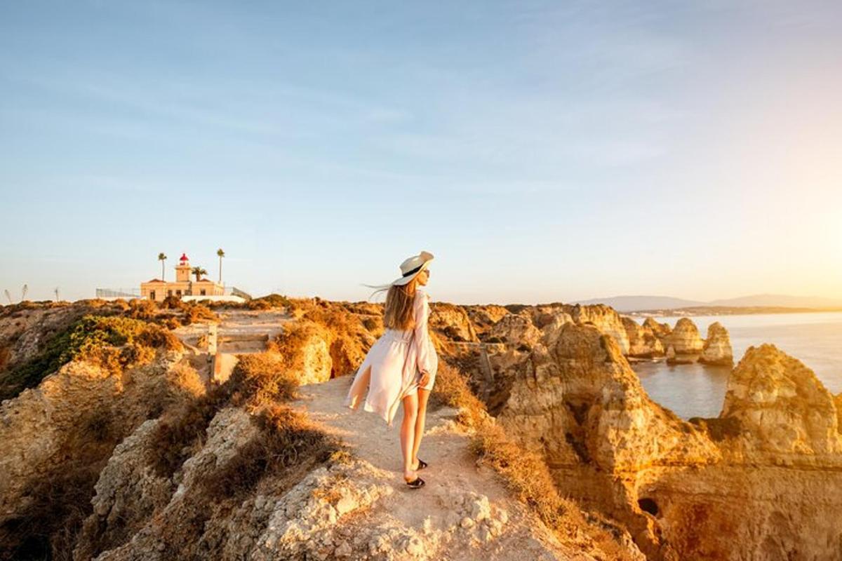 a woman walking on the rocks near the ocean