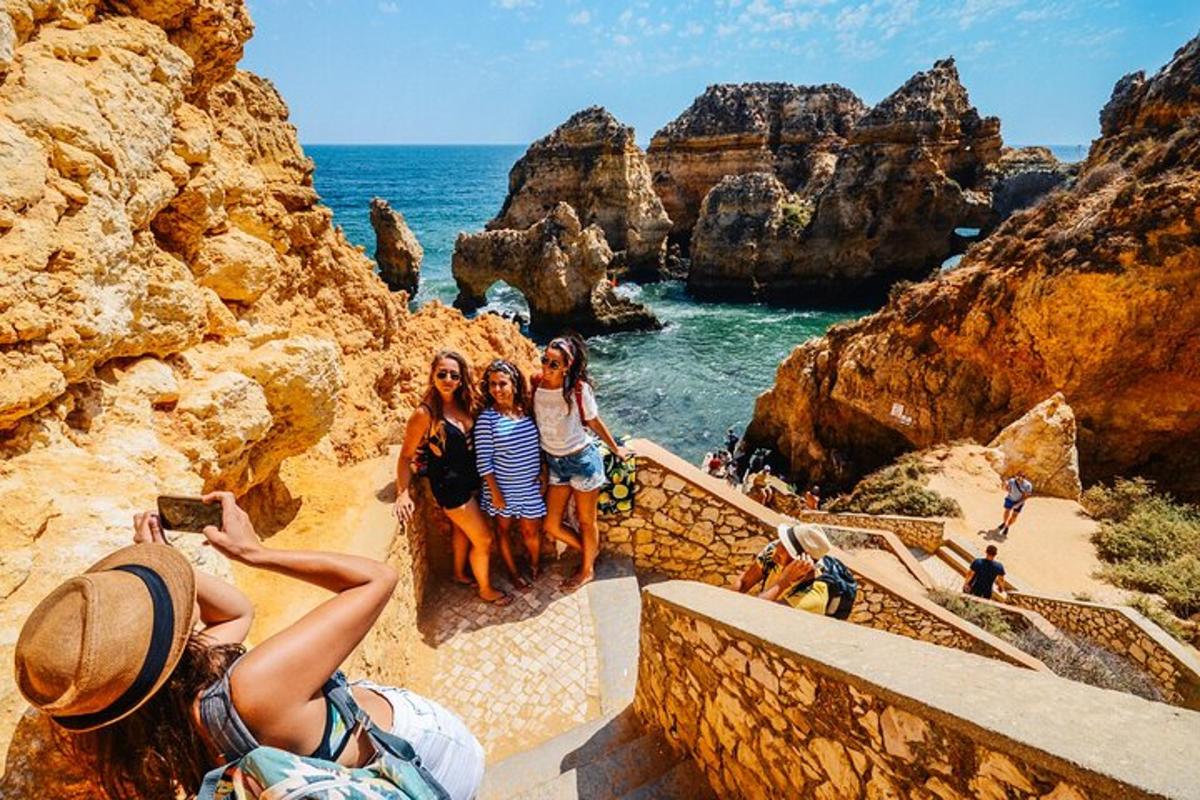 a group of people standing on stairs looking at the ocean