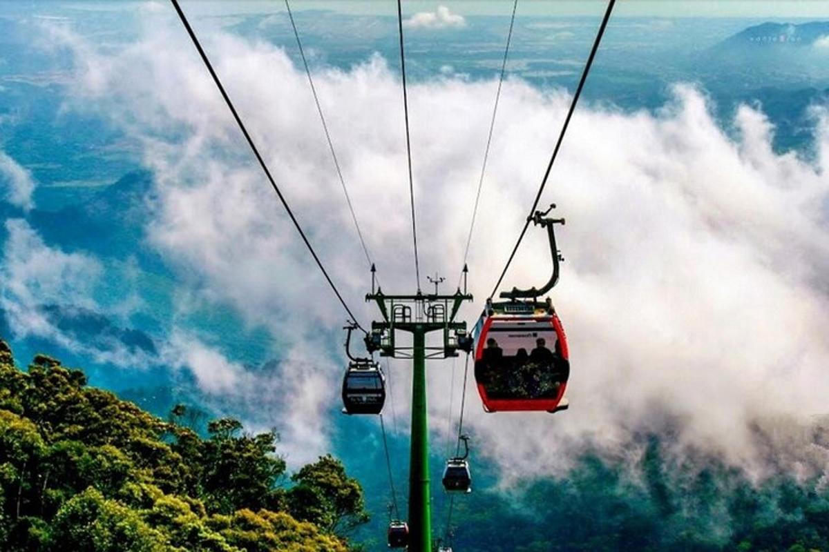 a group of people riding a ski lift in the sky