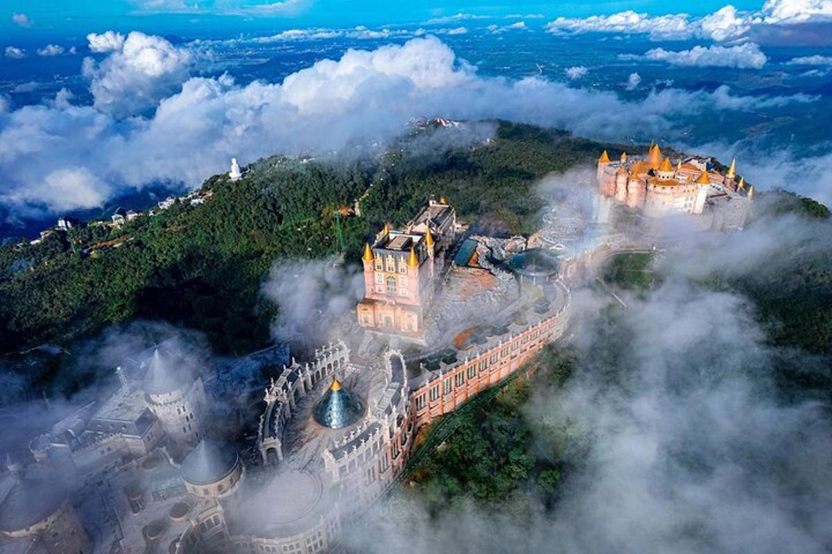 an aerial view of a castle in the clouds