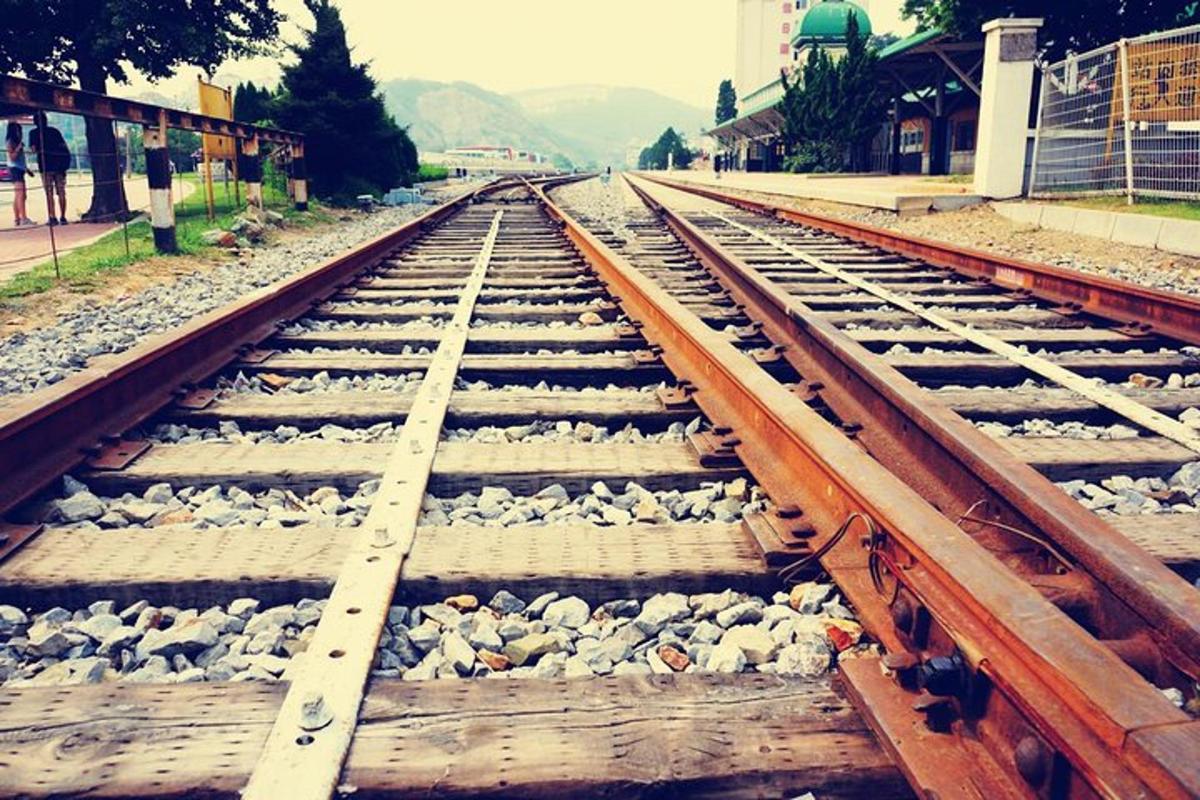 a set of train tracks with rocks on them