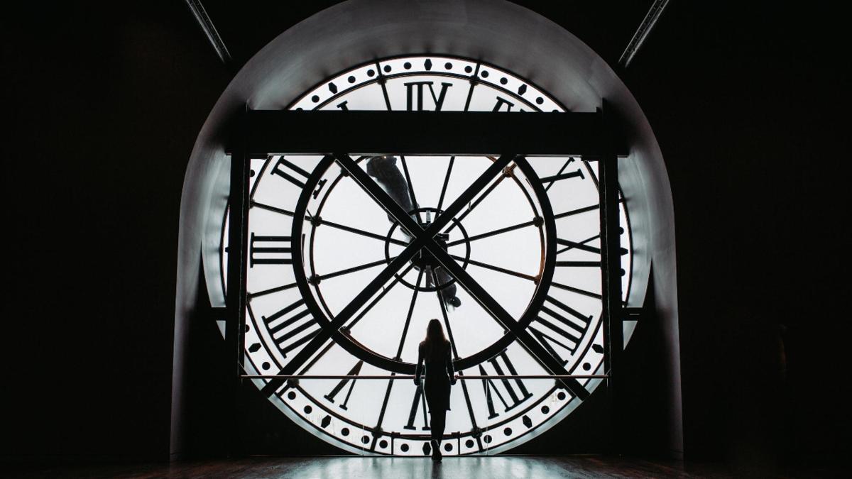 a person standing inside of a large clock tower