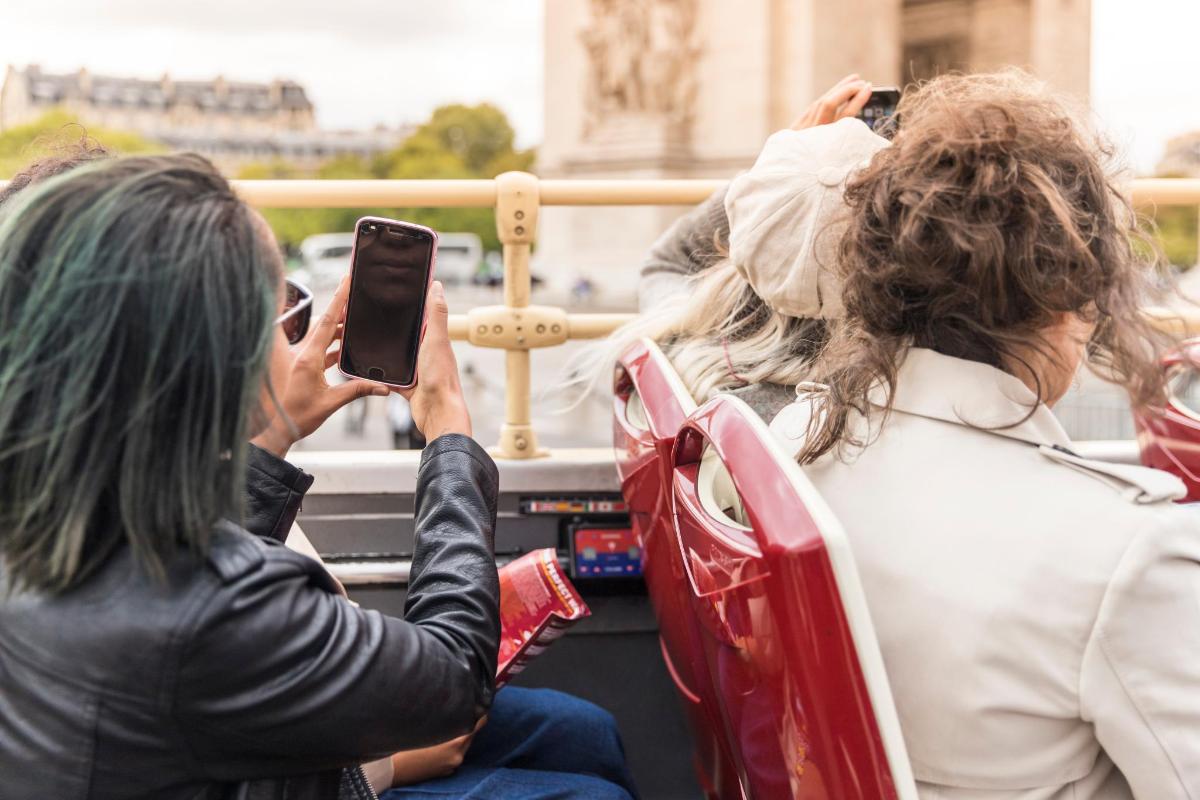 a woman taking a picture of a bride on a bus