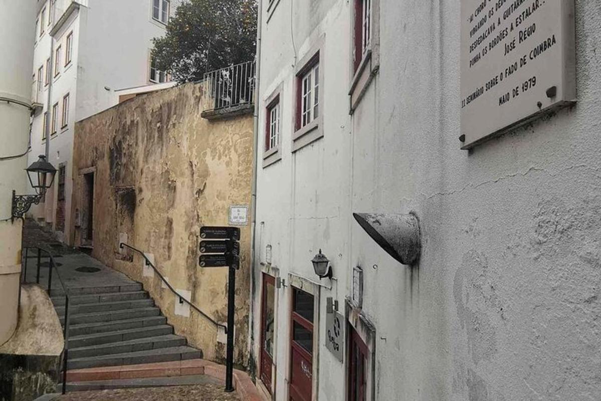an alley with stairs next to a building
